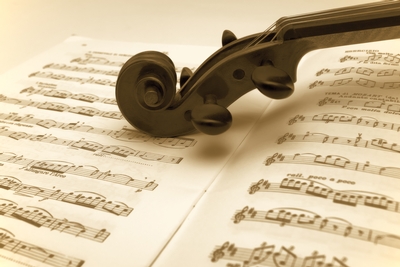 image of violin headstock on sheet music
